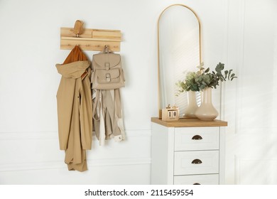 Stylish Hallway Interior With Coat Rack, Eucalyptus Branches And Mirror