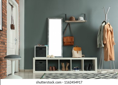 Stylish hallway interior with mirror and hanger stand
