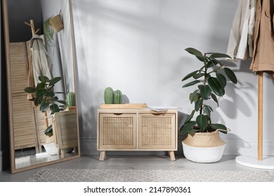 Stylish Hallway Room Interior With Wooden Commode, Coat Rack And Large Mirror