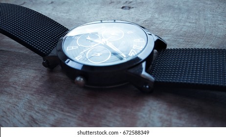 stylish hand watch on dark shed wood background