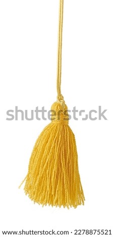 stylish handmade tussle or tassel isolated on white background, cut out of bright yellow decorative hanging tieback for creative projects