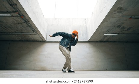 Stylish happy hipster perform break dance or freestyle foot step in building. Professional break dancer practice b-boy dance while wear stylish cloth. Modern lifestyle. Outdoor sport 2024. Sprightly.