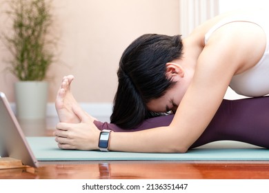 A Stylish Healthy Asian Woman Practicing Her Yoga Asana, One-legged Forward Bend Or Janusirsasana. Home Yoga, Online Course, Exercises, Wellbeing, Trends, Weight Loss, Mental Health, Breathing, Relax.