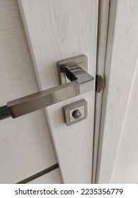 Stylish high-tech metal door handle on doors with a latch