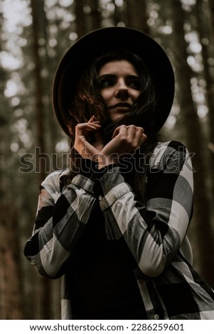 Similar – a girl with long hair and blue eyes in the mountain covering her face with her hair