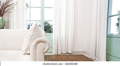 Stylish Home Living Room With White Sofa And Glass Doors.