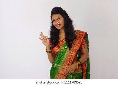 Stylish Indian Woman In Silk Saree And Nose Ring With OK Gesture. Front Pose