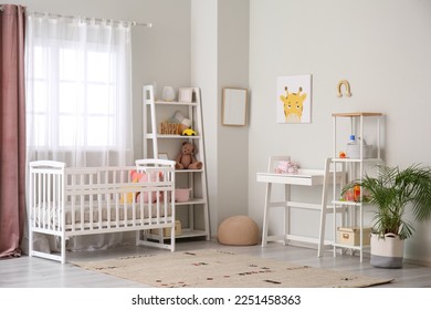 Stylish interior of children's room with baby bed