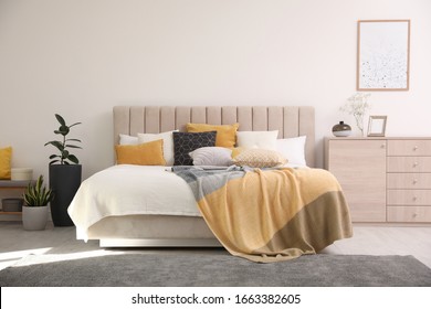 Stylish interior of contemporary room with comfortable bed - Shutterstock ID 1663382605