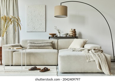 Stylish interior design composition of cozy living room with mock up poster frame and structure painting, corner sofa, coffee table, textile and personal accessories. Scandinavian classic style.