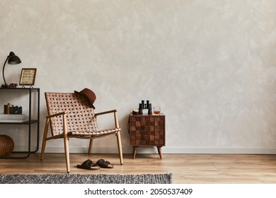 Stylish interior design composition of elegant masculine living room with copy space, brown armchair, designed commode, industrial shelf and personal accessories. Template.   - Shutterstock ID 2050537409