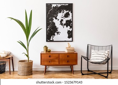 Stylish interior design of living room with wooden retro commode, chair, tropical plant in rattan pot, basket and elegant personal accessories. Mock up poster frame on the wall. Template. Home decor. - Shutterstock ID 1523679143