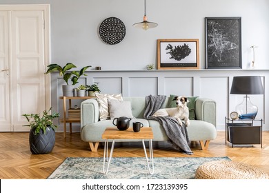 Stylish interior design of living room with modern mint sofa, wooden console, cube, coffee table, lamp, plant, mock up poster frame, pillows, plaid, decoration and elegant accessories in home decor. - Shutterstock ID 1723139395
