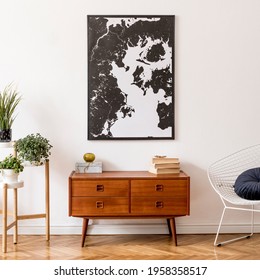 Stylish interior design of living room with wooden retro commode, white armchair, footrest and elegant personal accessories. Mock up poster frame on the wall. Template. Vintage home decor. - Shutterstock ID 1958358517