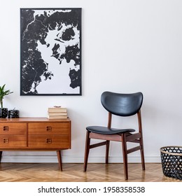 Stylish interior design of living room with wooden retro commode, chair, tropical plant in rattan pot, basket and elegant personal accessories. Mock up poster frame on the wall. Template. Home decor. - Shutterstock ID 1958358538