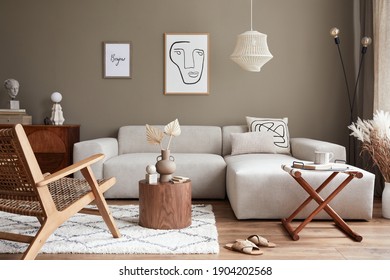 Stylish interior with design neutral modular sofa, mock up poster frames,  rattan armchair, coffee tables, dried flowers in vase,  decoration and elegant personal accessories in modern home decor.  - Shutterstock ID 1904202568