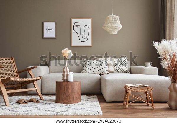 Stylish interior with design neutral modular sofa,\
mock up poster frames, rattan armchair, coffee tables, dried\
flowers in vase, decoration and elegant personal accessories in\
modern home decor.