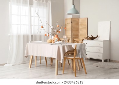 Stylish interior of dining room with Easter table setting