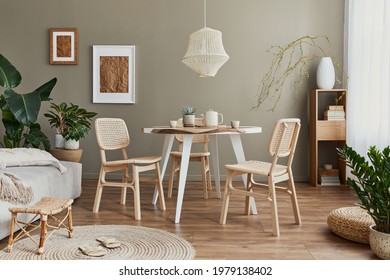 Stylish interior of dining room with family table, rattan chairs, pendatn lamp, plant, tableware, carpet, decoration and elegant accessories. Template. 