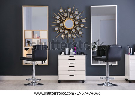Stylish interior with hairdresser's workplace in beauty salon