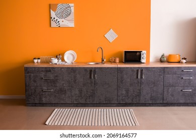 Stylish Interior Of Kitchen With Orange Wall