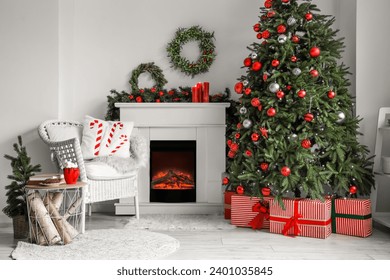 Stylish interior of light living room with fireplace and beautiful Christmas tree - Powered by Shutterstock