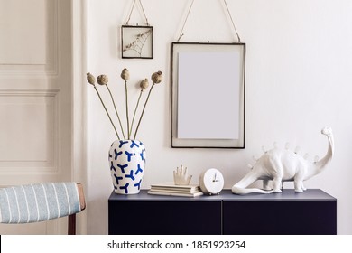Stylish interior of living room with bluenavy commode, mock up poster frame, decoration, book and elegant personal accessories in modern home decor. Template. 