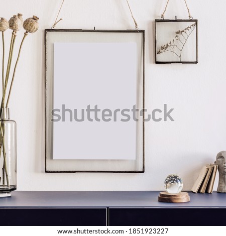 Stylish interior of living room with bluenavy commode, mock up poster frame, decoration, book and elegant personal accessories in modern home decor. Template. 