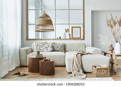 Stylish interior of living room with design modular sofa, furniture, wooden coffee table, rattan decoration, pendant lamp, pillow, dried flowers and elegant accessories in modern home decor. - Shutterstock ID 1904208253