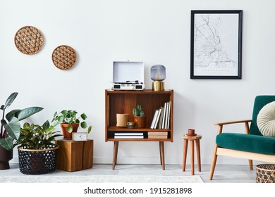 Stylish interior of living room with design wooden shelf, velvet sofa, a lot of plants, mock up poster map, vinyl recorder, book and personal accessories in vintage home decor. Template. - Shutterstock ID 1915281898