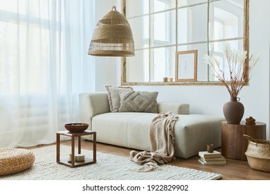 Stylish interior of living room with design modular sofa, furniture, wooden coffee table, rattan decoration, mock up picture frame, pillow, dried flowers and elegant accessories in modern home decor.