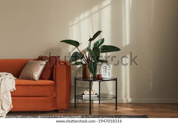 Stylish interior\
of living room at fancy home with design sofa, marble side table,\
plant, pillow, blanket, book and personal accessories in modern\
home decor. Template. Copy\
space.