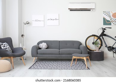 Stylish interior of living room with grey furniture and air conditioner - Shutterstock ID 2168060385