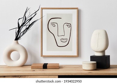 Stylish interior of living room with mock up poster frame, wooden commode, book, black leaf in ceramic vase and elegant personal accessories. Minimalist concept of home decor. Template. - Powered by Shutterstock