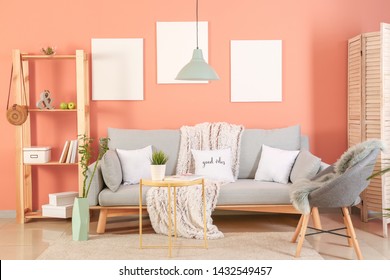 Stylish interior of living room near color wall