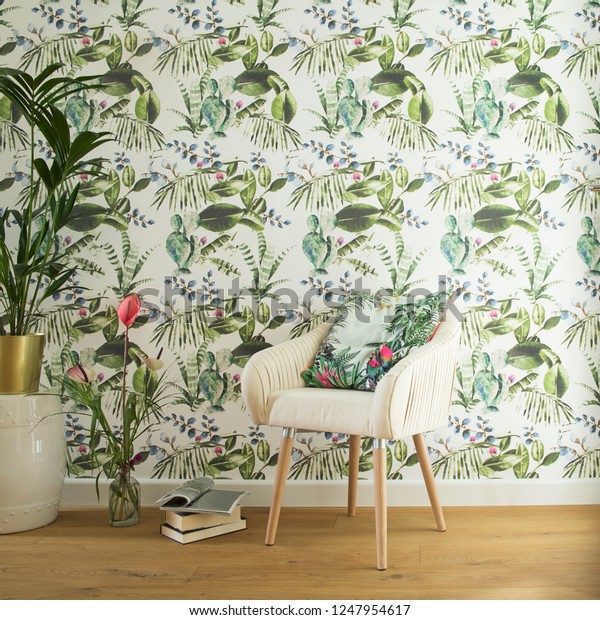 Stylish interior, lovely and bright space to read books or to studdy interior magazines. Floral pattern wallpaper and design armchair.