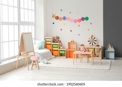 Stylish interior of modern playroom in kindergarten - Shutterstock ID 1902560605