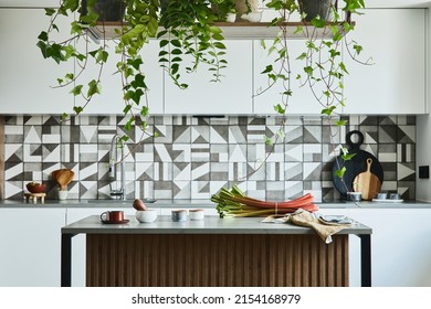 Stylish kitchen interior design with dining space. Workspace with kitchen accessories on the back ground. Creative walls with woode pannels. Minimalistic style an plant love concept.  - Powered by Shutterstock