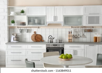 Stylish Kitchen Interior With Dining Table And Chairs