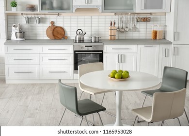 Stylish Kitchen Interior With Dining Table And Chairs