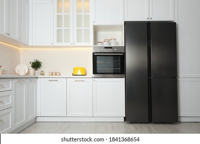 Stylish kitchen interior with modern steel refrigerator