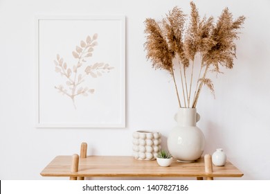 Stylish korean interior of living room with white mock up poster frame, elegant accessories, air plant, wooden shelf and vase with flowers. Minimalistic concept of home decor. Template. Bright room.