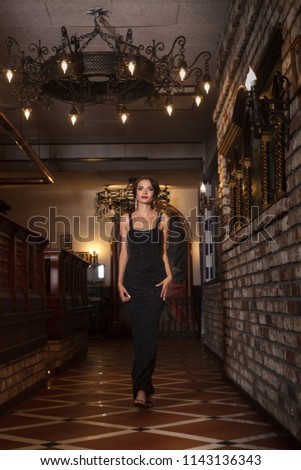 Stylish lady posing like a model in luxurious hall