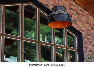 Stylish lampshade outside the house. Orange and black lampshade in front of stylish house.
