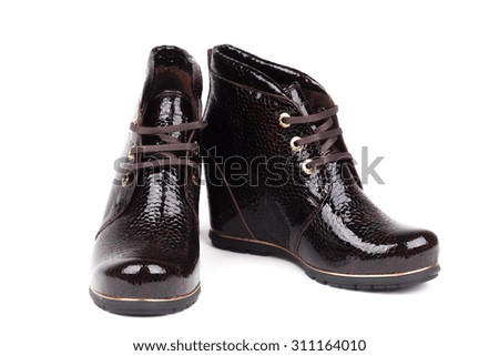 Stylish leather boots shot in studio, isolated on white