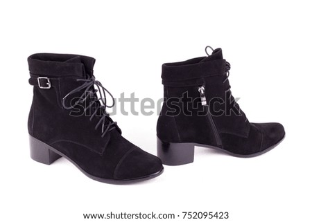 Stylish leather boots shot in studio, isolated on white background.