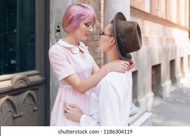 Stylish Lesbian Couple Hugging Near The Old Building In The City