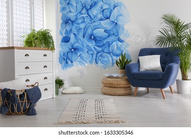 Stylish Living Room With Blue Flowers Painted On Wall. Floral Pattern In Interior Design