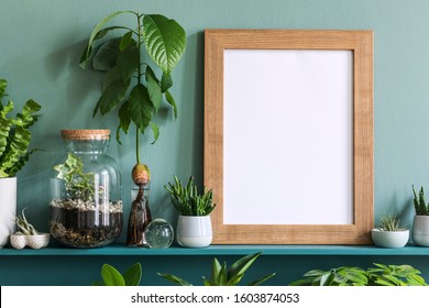 Stylish Living Room Interior With Brown Mock Up Photo Frame, Beautiful Plants In Differents Hipster And Design Pots On The Green Shelf. Modern And Floral Concept Of Home Garden Jungle. Template. 