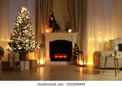 Stylish Living Room Interior With Christmas Tree Near Beautiful Fireplace, Blurred View